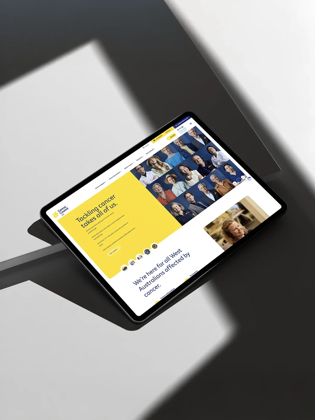 Ipad on a cement background featuring a cancer council website