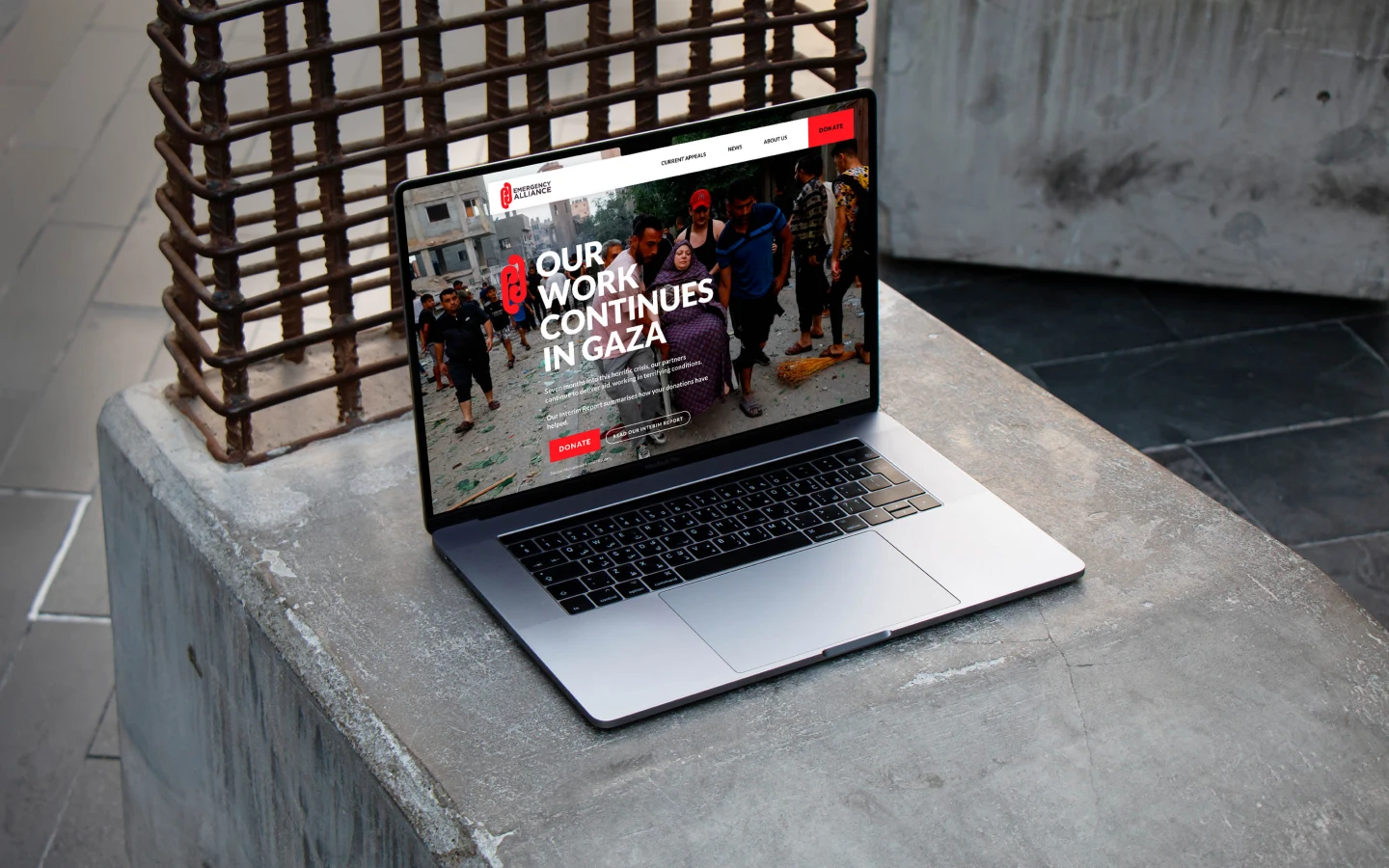 Computer on concrete with a website showing