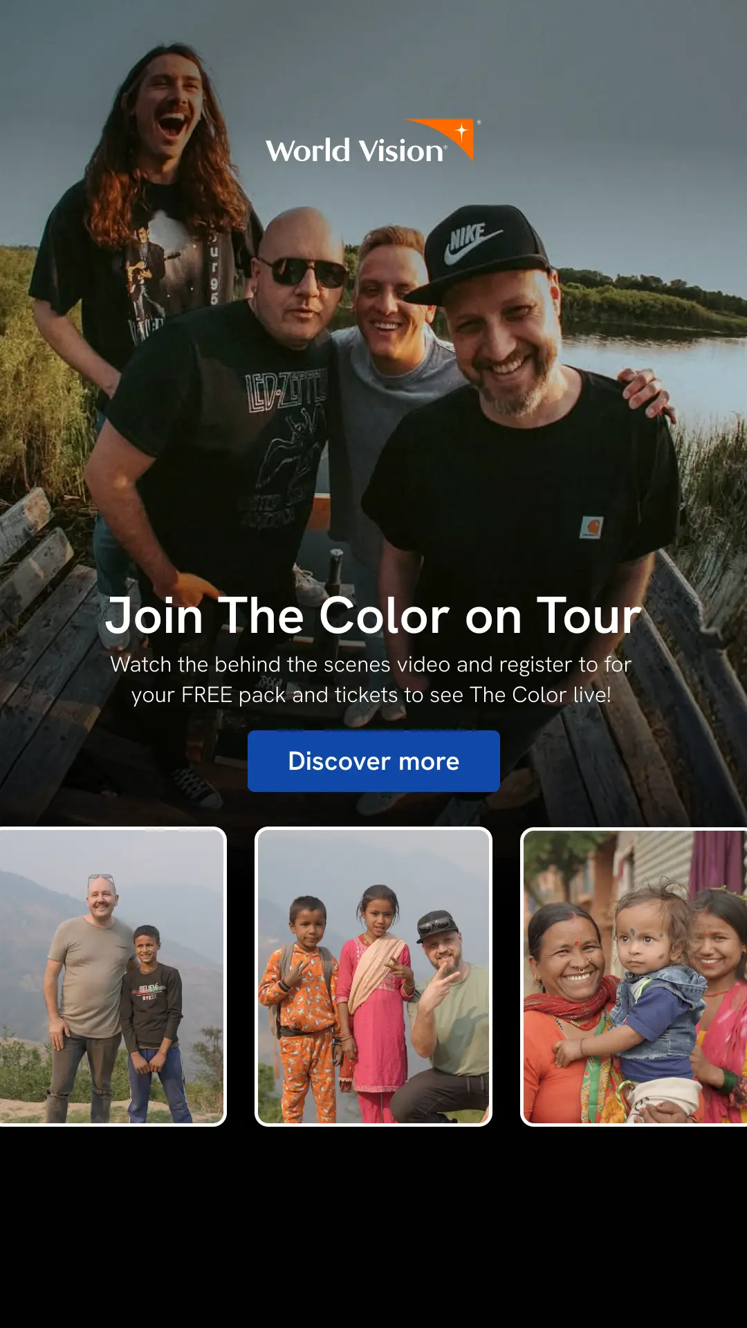 Four men smiling at camera wearing black tshirts