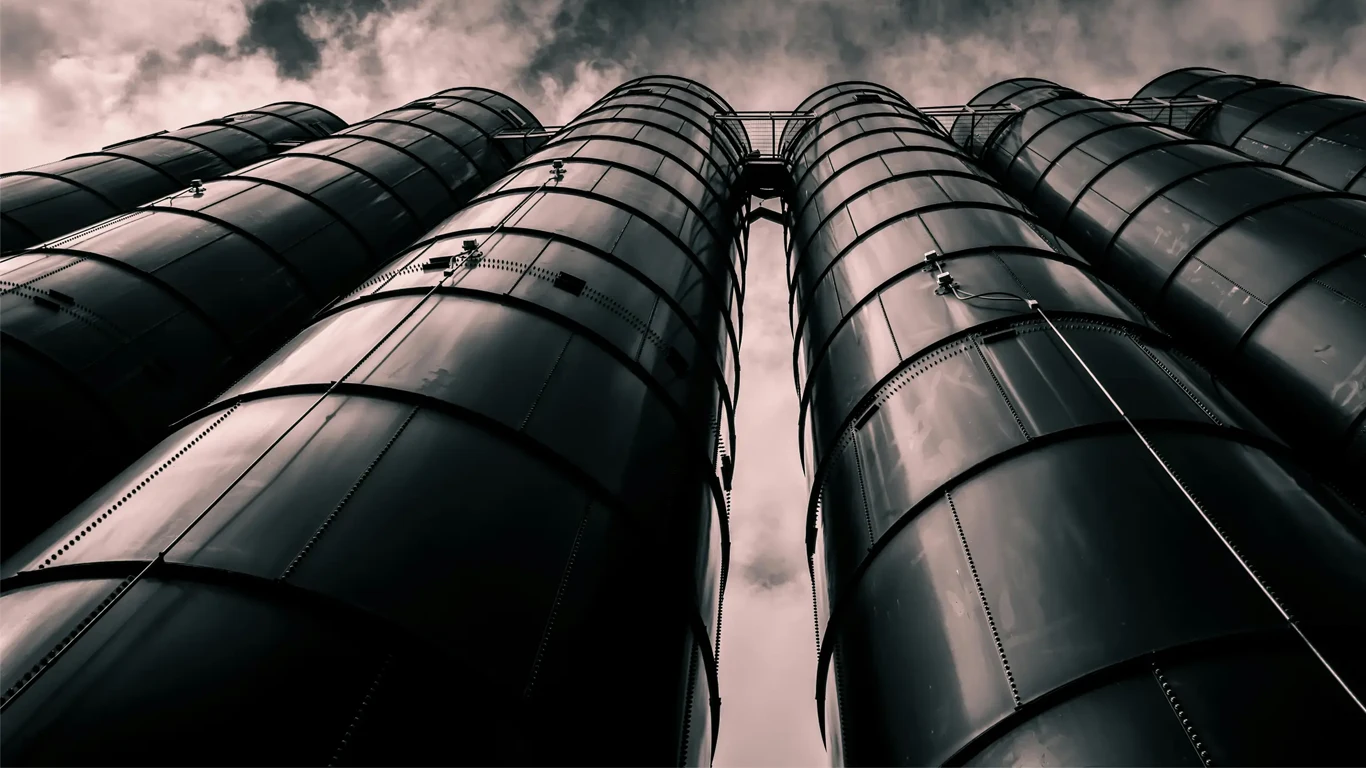 Looking up at four large silos