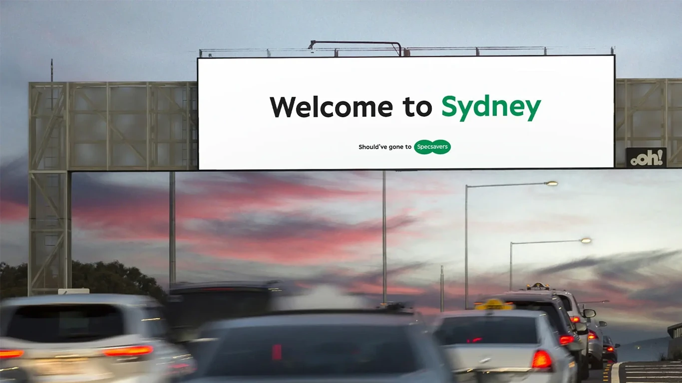 A billboard at the exist of Melbourne airport that reads welcome to Syndey